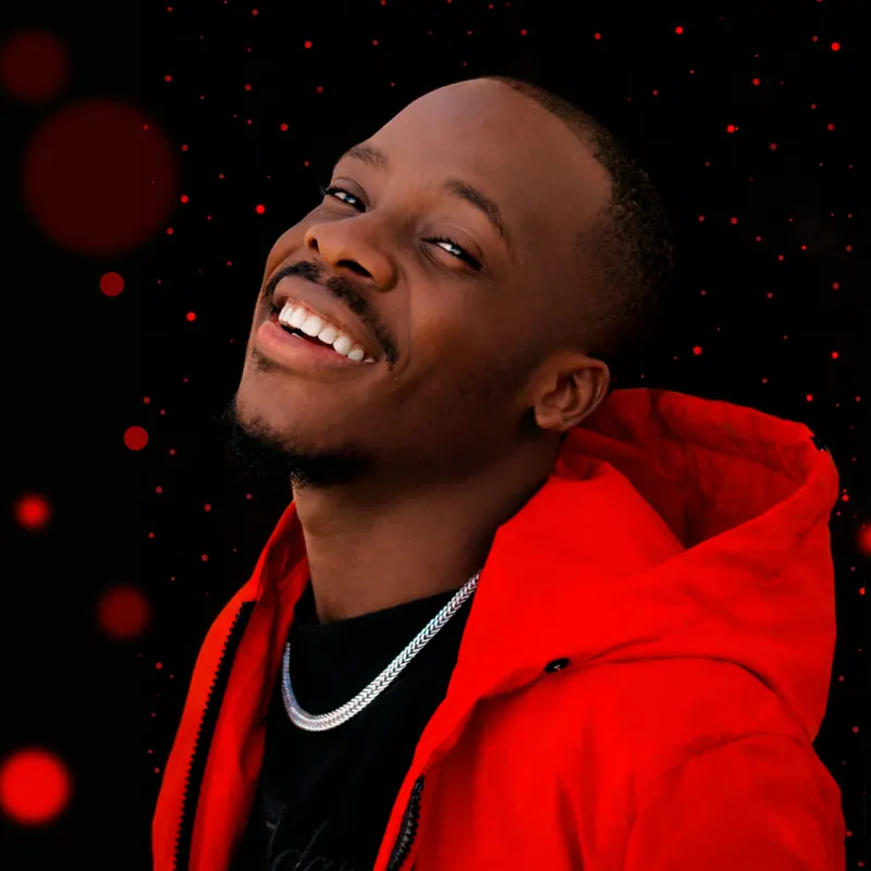 Portrait of Paddy Daniel smiling in a red hoodie