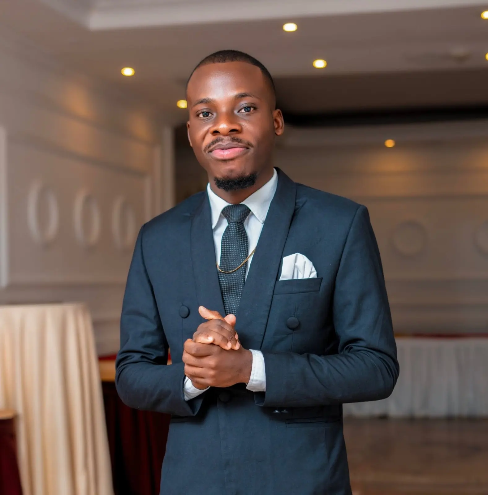 Paddy Daniel in a navy suit with a pocket square